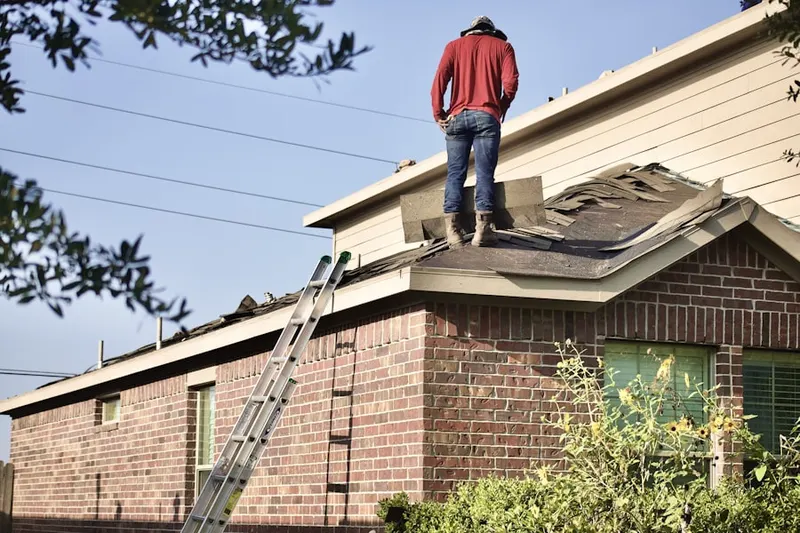 Professional roofer working on a residential roof in Belltown